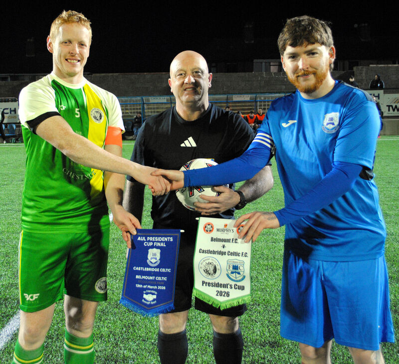 Belmount Celtic's James Kelleher exchanges pennants with Castlebridge Celtic's Cian O'Driscoll, watched by referee Patrick O'Herlihy.