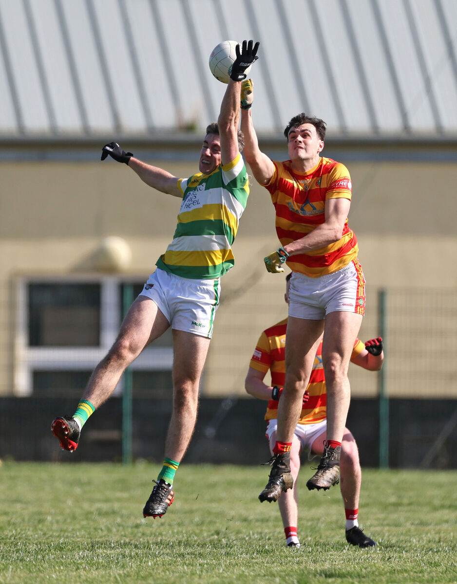 Newcestown's Sean O'Donovan and Kelan Scannell battle for aerial possession. Picture: Jim Coughlan