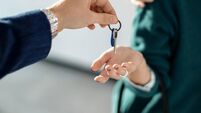Close-up of a couple receiving key of their new real estate.
