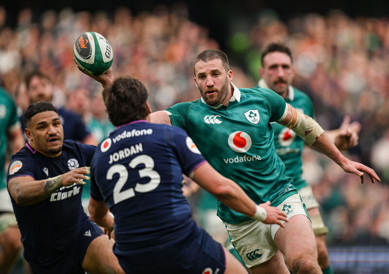 Stuart McCloskey offloads under pressure from Tom Jordan in the build-up to Ireland's sixth try. Picture: Brendan Moran/Sportsfile