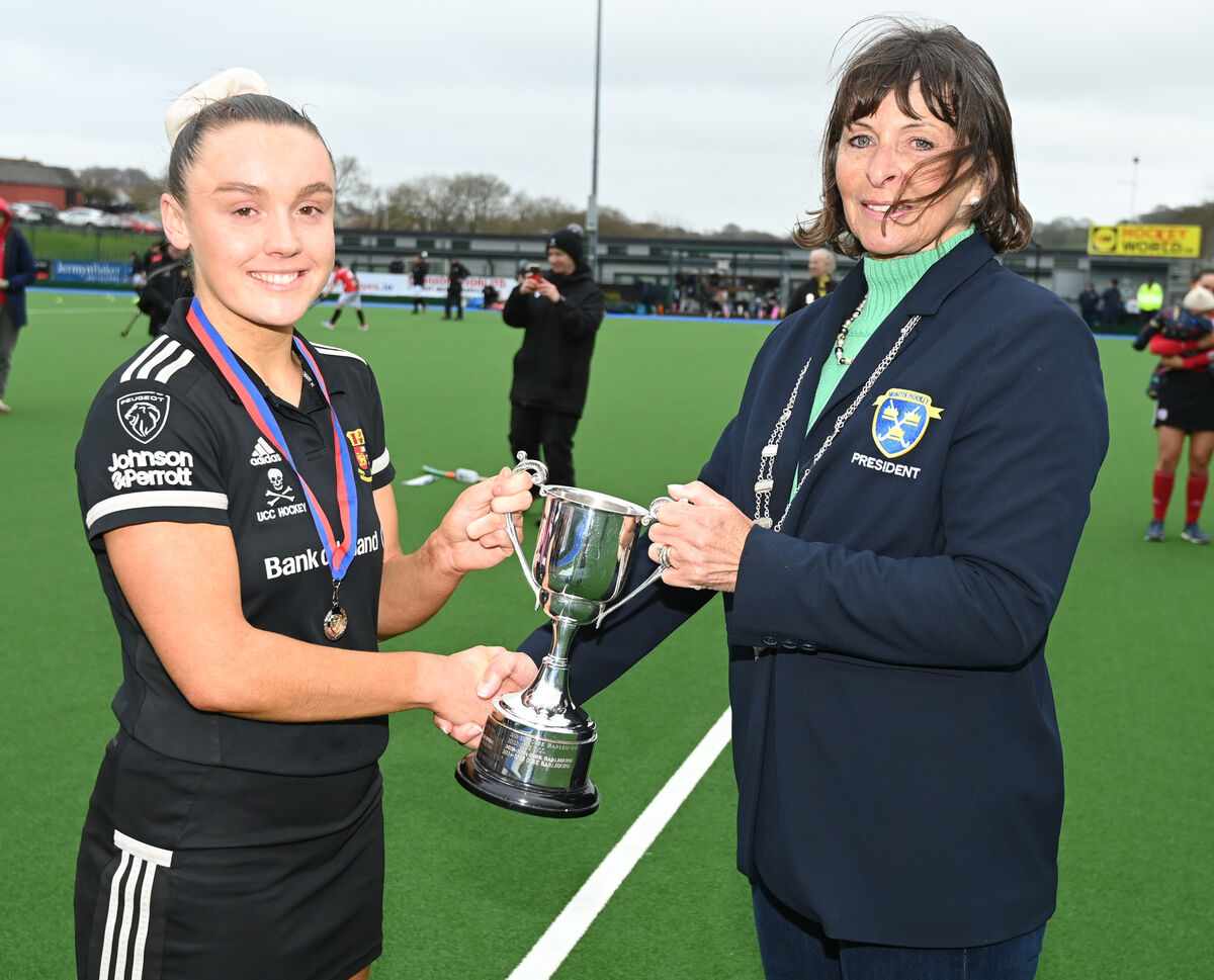 Nicky Stokes president Munster branch presents the trophy to UCC captain Lauren Cripps after defeating Harlequins in the ladies Munster senior cup final at Garryduff. Picture: Eddie O'Hare