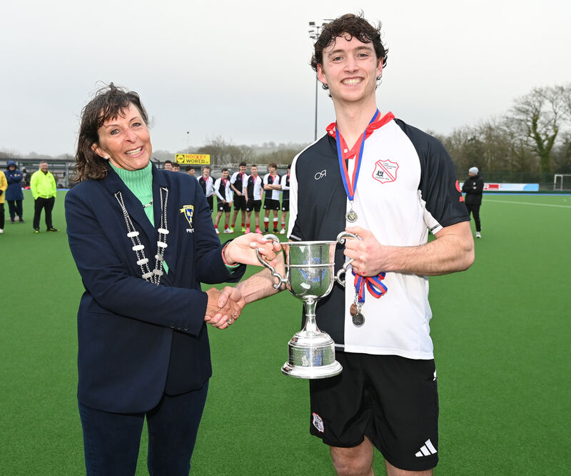 Nicky Stokes, president Munster branch, presents the trophy to Harlequins captain Julian Dale after defeating Catholic Institute in the Men's Munster Senior Cup final at Garryduff. Picture: Eddie O'Hare