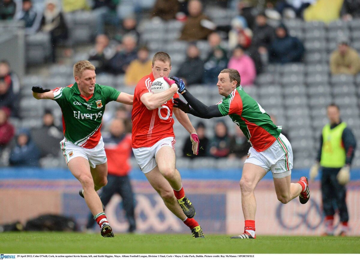 Colm O'Neill, Cork, in action against Kevin Keane and Keith Higgins, Mayo, in the 2012 Allianz Football League, Division 1 final at Croke Park. Picture: Ray McManus/SPORTSFILE