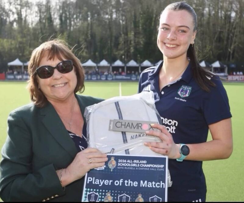 Barbara O'Malley, president Irish Hockey, presents Sofie Moloney with her Player of the Game award after the Daphne Hall Cup final.