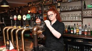 <p class="contextmenu internal_Caption">Michaela Twomey behind the bar counter at The Hunted Hog at Castlemartyr, Co Cork. 	<span class="contextmenu emphasis CaptionCredit">Picture: Larry Cummins</span>
            </p>