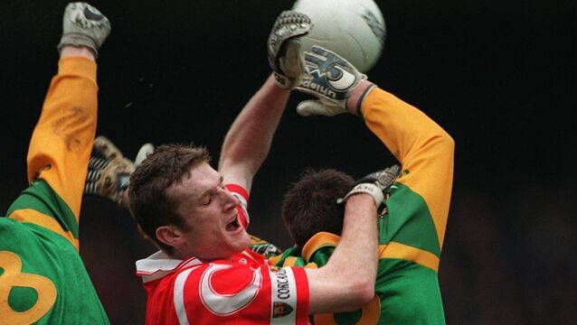 <p>Cork legend Nicholas Murphy rising high against Meath in the 1999 league semi-final. Picture: INPHO/Billy Stickland</p>