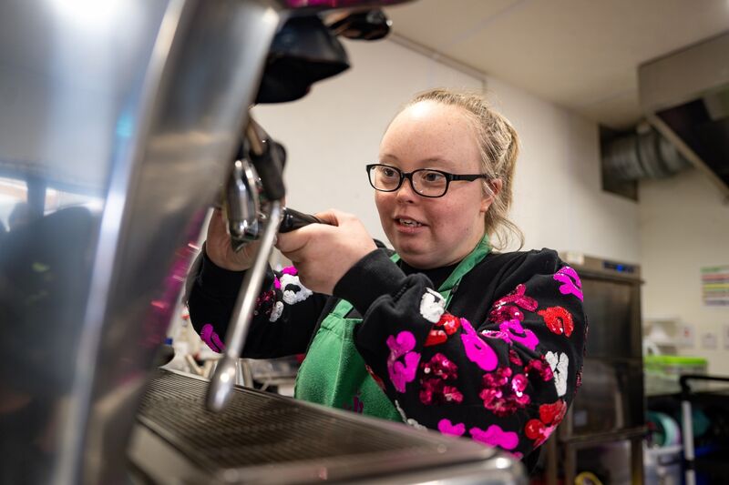 Clodagh Robins practises her barista skills at the Field of Dreams as she celebrates her 22nd birthday. 