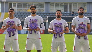 Iran wear black armbands and hold schoolbags during national anthem before match Iran wear black armbands and hold schoolbags during national anthem before match
