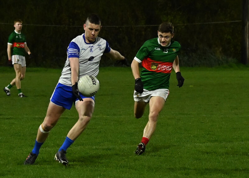 Fintan O'Connor fires a pass as Sean McEvoy closes in. Picture: Martin Walsh.