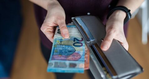 Woman taking out money from wallet