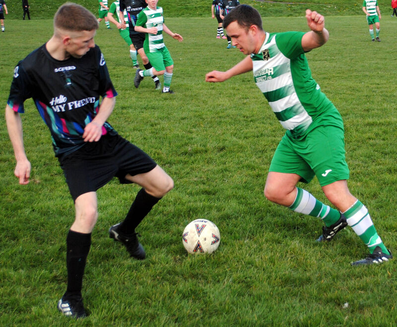 Knocknaheeny's Evan Hourigan and Glenthorn's David Busher scrap for possession at Kilmore Road. Picture: Barry Peelo.