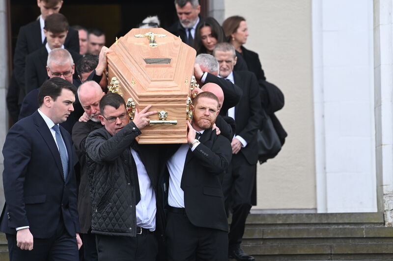  The coffin is shouldered from the church. Picture: Larry Cummins.