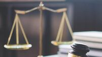 iStock-939262058.jpg Scales of justice and Gavel on wooden table and Lawyer or Judge working with agreement in Courtroom, Justice and Law concept