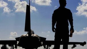 <p class="contextmenu internal_Caption">A British soldier beside a Typhoon aircraft at RAF Akrotiri in Cyprus. The locals are debating the future of the bases after the recent drone attack there, part of the widening Middle East conflict</p>