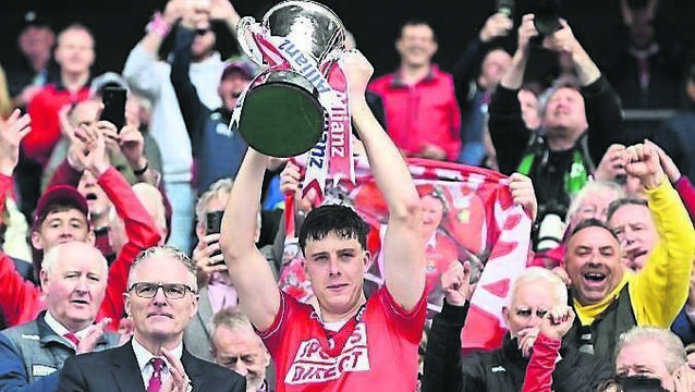 <p class="contextmenu internal_Caption">Cork captain Robert Downey lifts the Allianz League trophy last year</p>