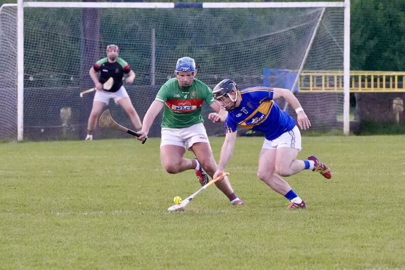 Carrigtwohill’s James Mulcahy picks up the ball as  Fr O’Neill's Mark O’Neill moves in to challenge him during their league clash at Carrigtwohill. Picture:  Noel Sweeney