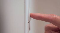 Closeup detail of male finger pushing light switch