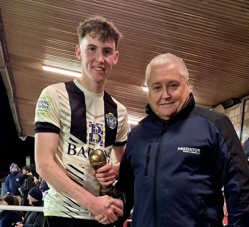 Douglas Hall's Eoin Gibson receiving the Man of the Match award from James Daly after the Daly U19 Cup final.