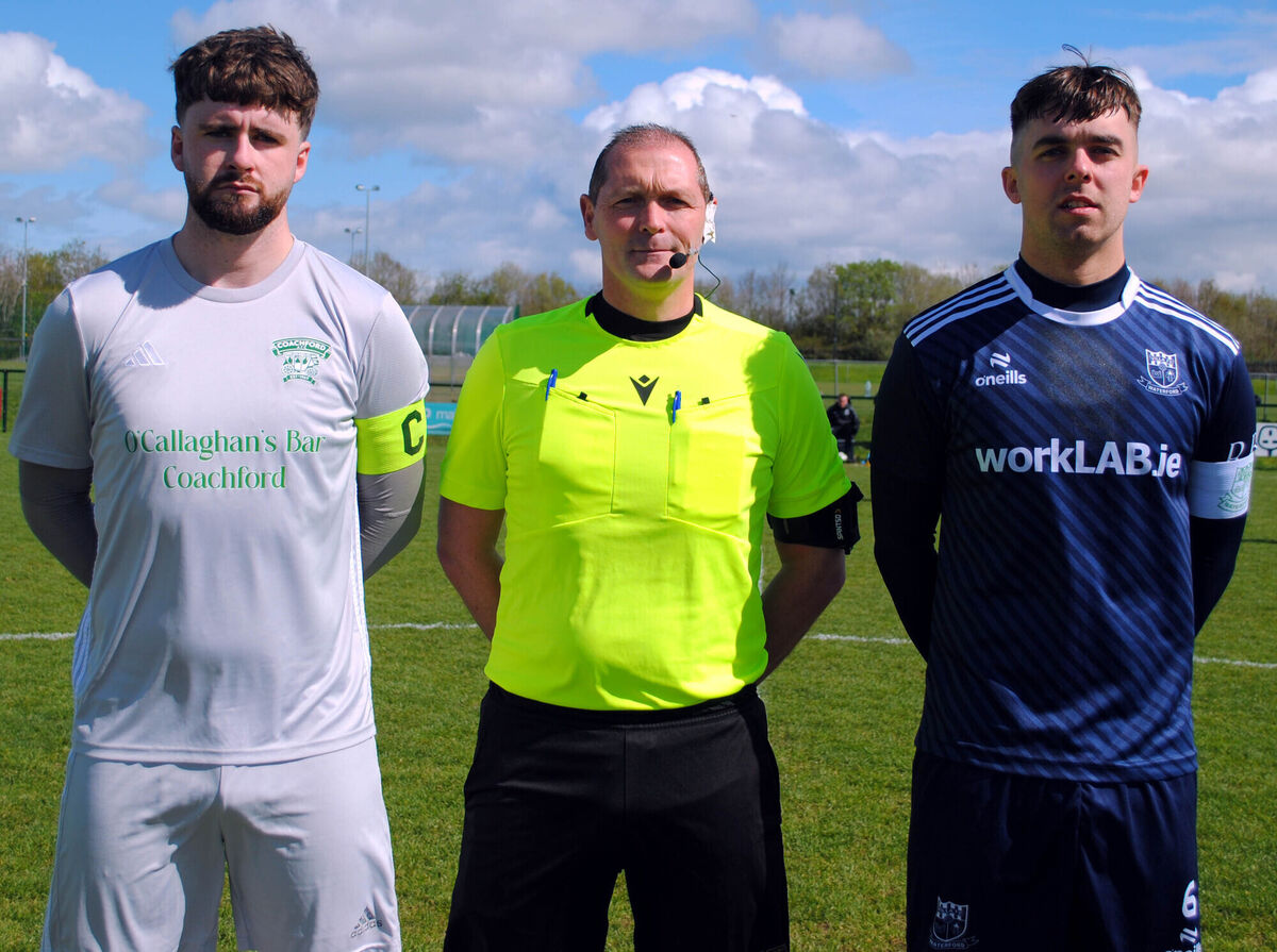 Coachford captain Mark Murphy (left), with Villa FC's Luke Walsh, accompanied by referee Brian Higgins. Picture: Barry Peelo. Coachford captain Mark Murphy (left), with Villa FC's Luke Walsh, accompanied by referee Brian Higgins. Picture: Barry Peelo.