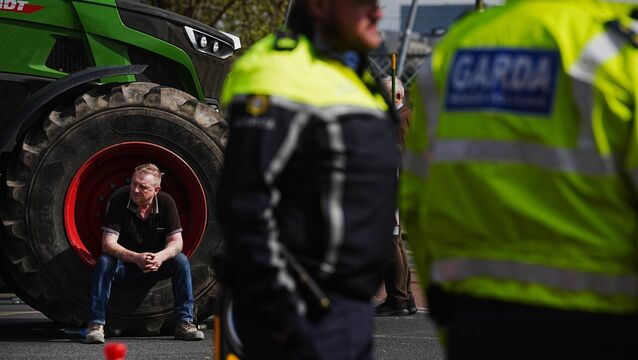 <p>A man sits in a tractor wheel as vehicles are parked on O'Connell Street in Dublin as protestors take part on the second day of a National Fuel Protest against rising fuel prices. Picture: Brian Lawless/PA Wire</p>