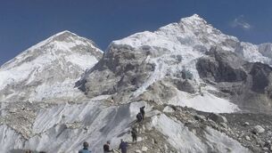 <p class="contextmenu internal_Caption">Trekkers pass through a glacier at the Mount Everest base camp in Nepal.</p>