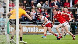 Noah Grimes scores a point despite the efforts of Cormac McKeown and Keelin Martin 28/5/2025