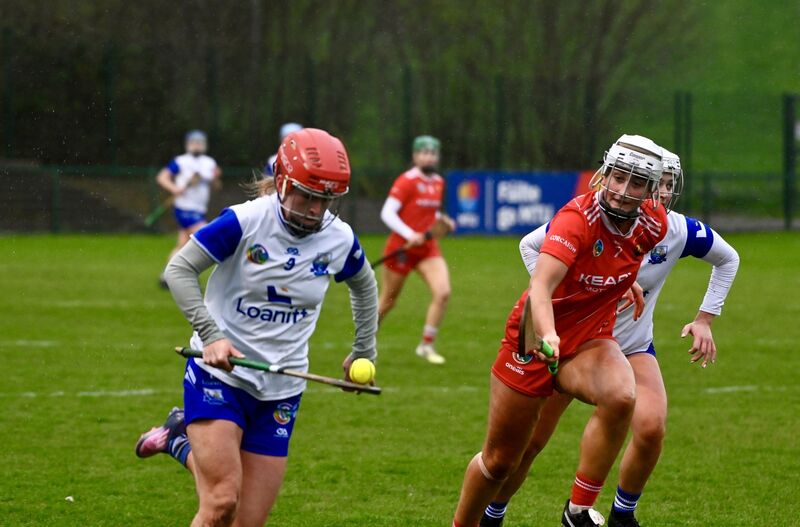 Holly O’Sullivan of Waterford solos past Cork’s Eimear Duignan. Picture: Noel Sweeney