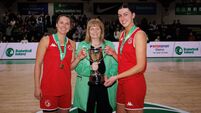 Mila Pichet and Abby Murphy are presented with the trophy by Margaret Miley 12/4/2026