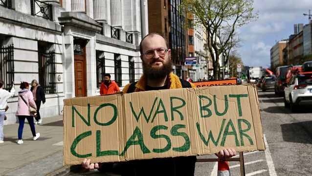 <p>Fionn Kelleher supporting the slow protest as it passes the South Mall in Cork city on Sunday afternoon. Picture: Noel Sweeney</p>