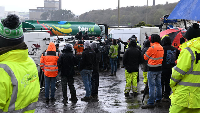 <p> Fuel trucks heading to the oil refinery under garda escort are watched by protesters at Whitegate village on Saturday afternoon. Picture: Larry Cummins</p>