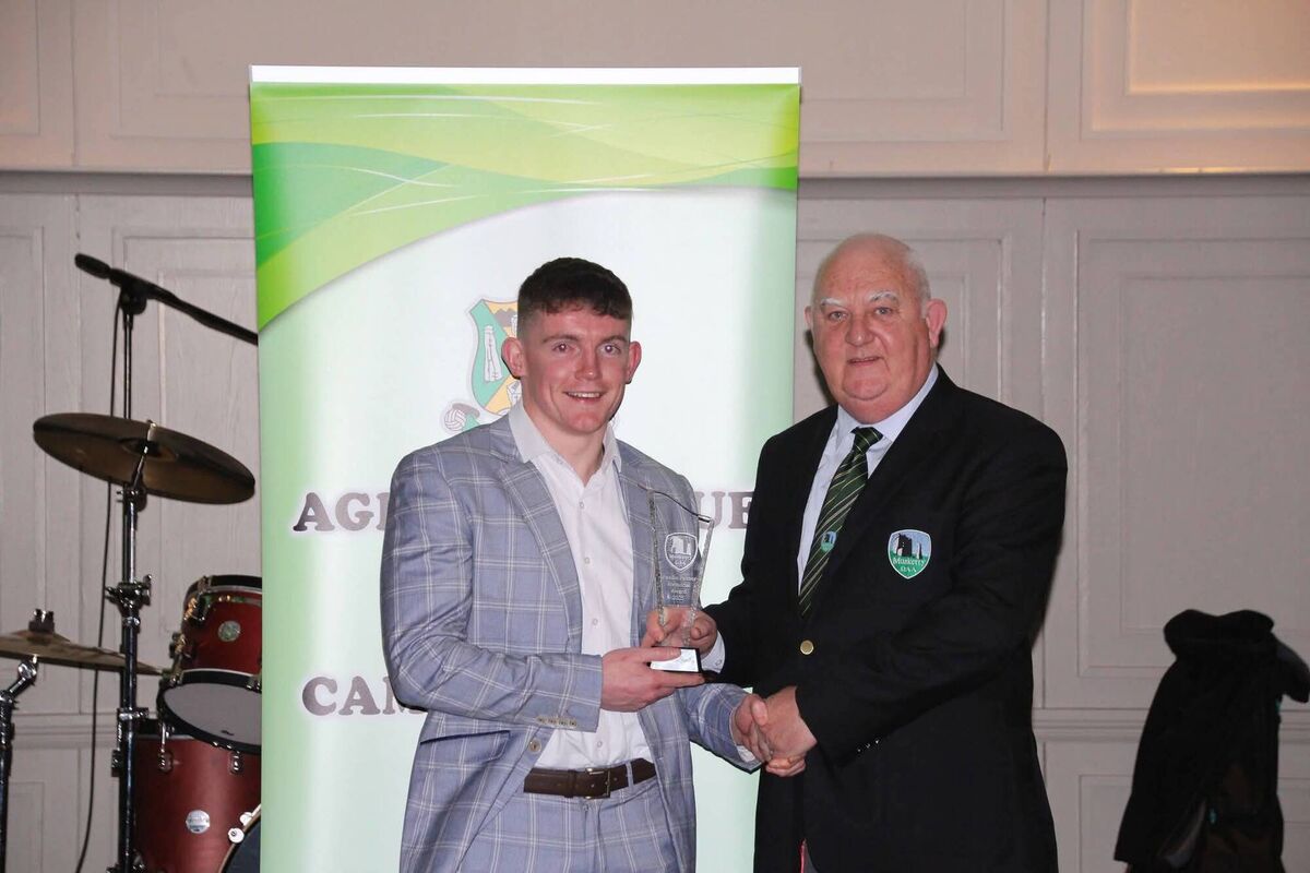 Muskerry GAA PRO Michael Dilworth presents an award to Aghabullogue dual star Matthew Bradley. 