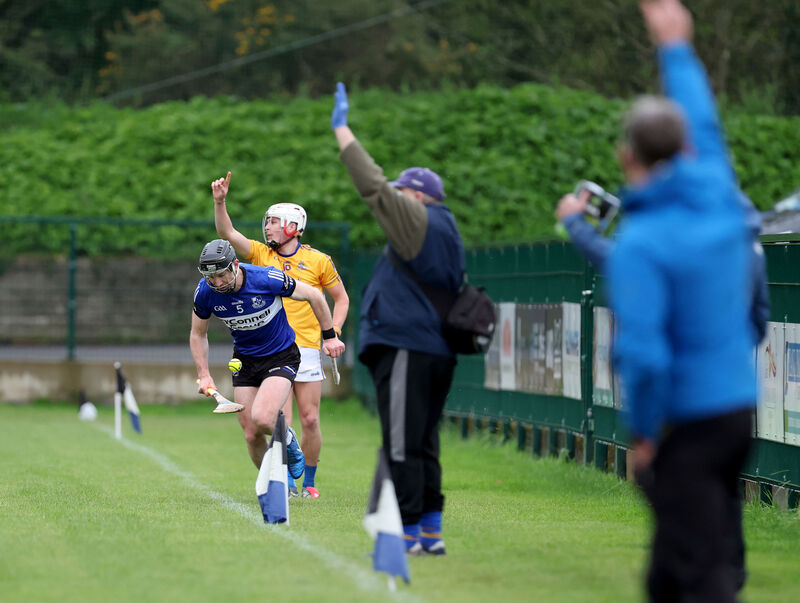  Bryan Murphy drives up the field for Sarsfields as John Wiggington Barrett calls the ball out. Picture: Jim Coughlan.