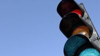Close-up of traffic lights against blue sky