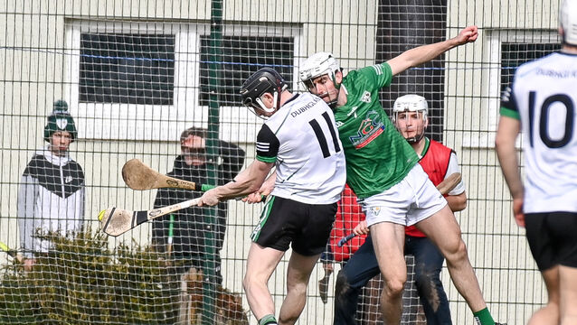 <p> Douglas' Mark O'Brien hammers the ball to the Killeagh net despite the efforts of Cathal Fitzgibbon during their Cork SHL clash in Killeagh.</p>
