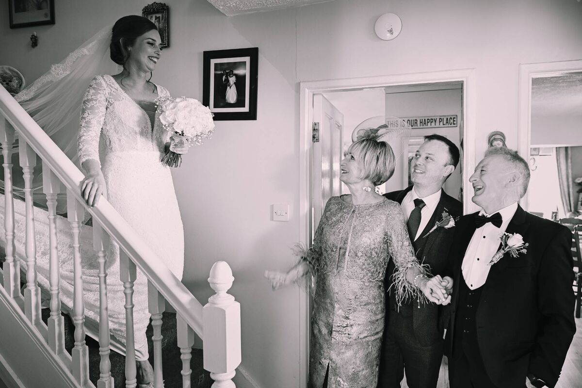 Rebecca comes down the stairs where she is greeted by Mary, Darren, and Kieran. 