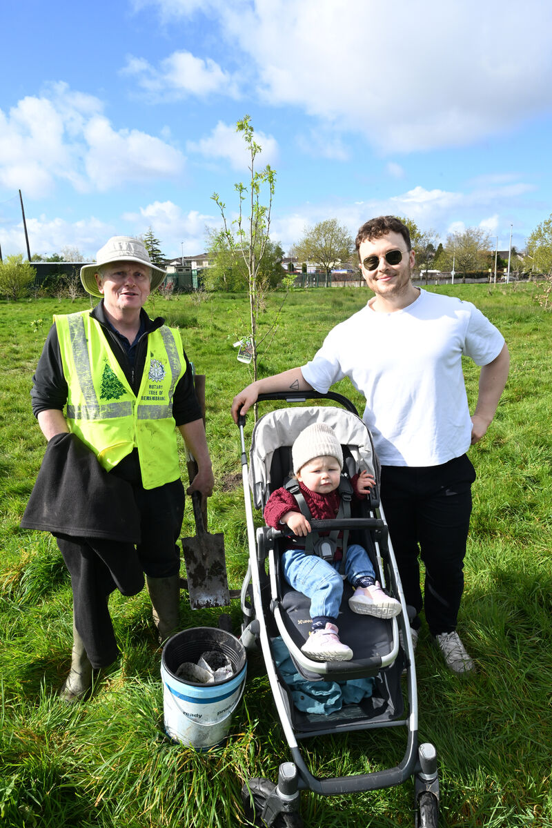 Richard Nunan with his son Peter and grandchild Ruby at the grove planting. 