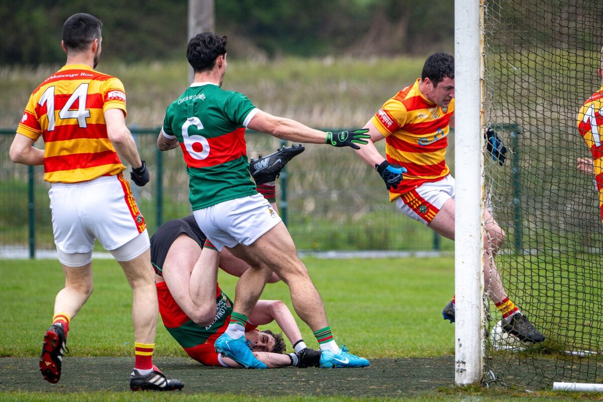  Clon keeper Mark White hits the deck as Micheál McSweeney closes in on goal for Newcestown. Picture: Chani Anderson