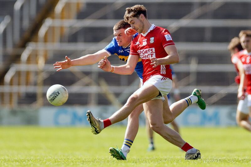 Paul Walsh fires a pass from Joe Higgins of Tipperary. Picture: INPHO/Laszlo Geczo
