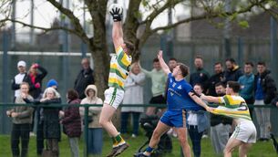 <p>St Finbarr's Bill O’Connell is held back as Carbery Rangers' John O’Brien rises high to field the ball. Picture: Chani Anderson</p>