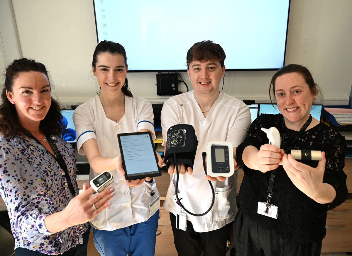 At the virtual monitoring hub in the hospital ward are (rear) Anna Higgins, service improvement lead, Alison Lane, assistant director of nursing, and Aidan Ryan, staff nurse with (seated ) staff nurse Jennifer O’Connell with the box containing the Doccla virtual care home monitoring kit. Picture Larry Cummins.