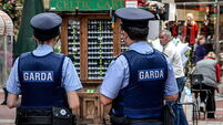 The Garda (Police) often patrol in pairs on busy Grafton Street, popular with visitors and tourists in Dublin, Southern Ireland.