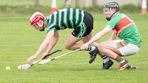 <p>Liam Kelleher of Douglas reaches out for the sliothar ahead of John Millerick of Fr O'Neill's during their Red FM SHL match at Aghavine. Picture: Howard Crowdy</p>