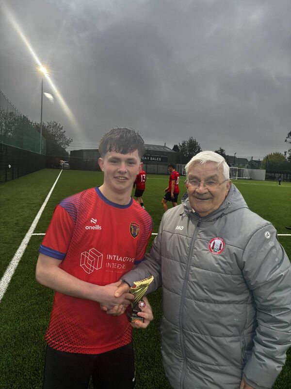 Christy Byrne from the Cork Youth League presenting the Gary McCarthy Trophies man of the match award to Leeside  United hat-trick hero JJ Foley after the U18 Premier game at Knockgriffin 