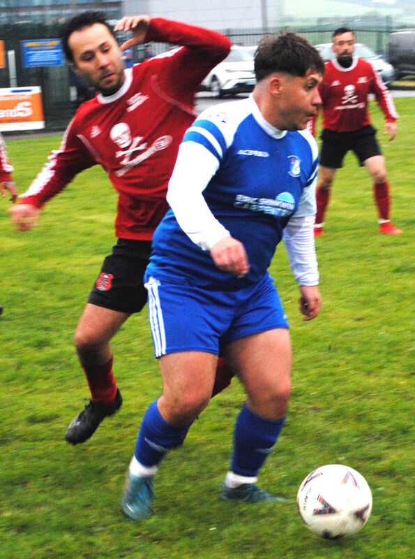 Grattan B's Dominic Wojtas looks for an option as UCC B's Gokhan Dumlupinar closes in.
