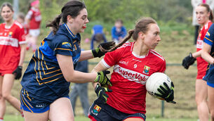 <p>Cork's Rose Murphy turns away from the challenge of Tipperary's Louise McGrath during their Munster LGFA Senior B Championship match at Carrigaline. Picture: Howard Crowdy</p>