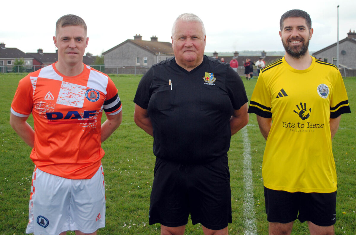 Cathedral Celtic's Jonathon O'sullivan (left), with Blackpool Celtic's Craig Horgan, accompanied by referee Jim Hennessy.