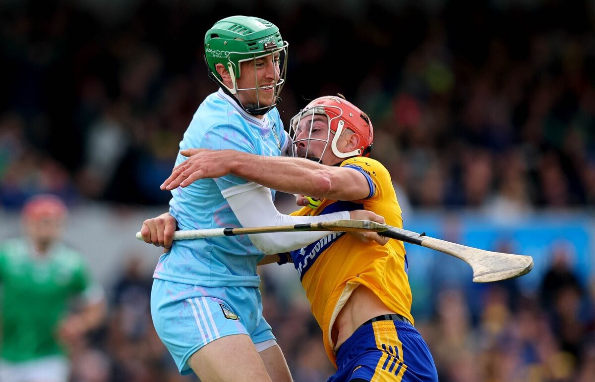 Clare’s Peter Duggan tackles Limerick goalkeeper Nickie Quaid. Picture: INPHO/Ryan Byrne
