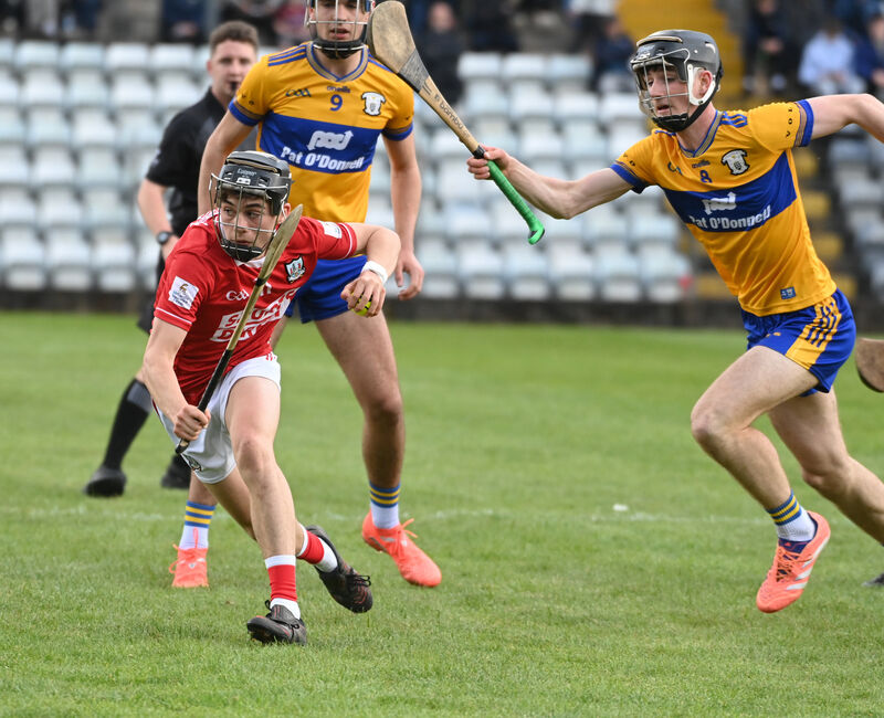 Cork's Bobby Power racing away from Clare's Oran Duigan and Isaac Hassett. Picture: Eddie O'Hare