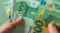 salary of a woman. euro banknotes in hands on a green background. Income of women in European countries