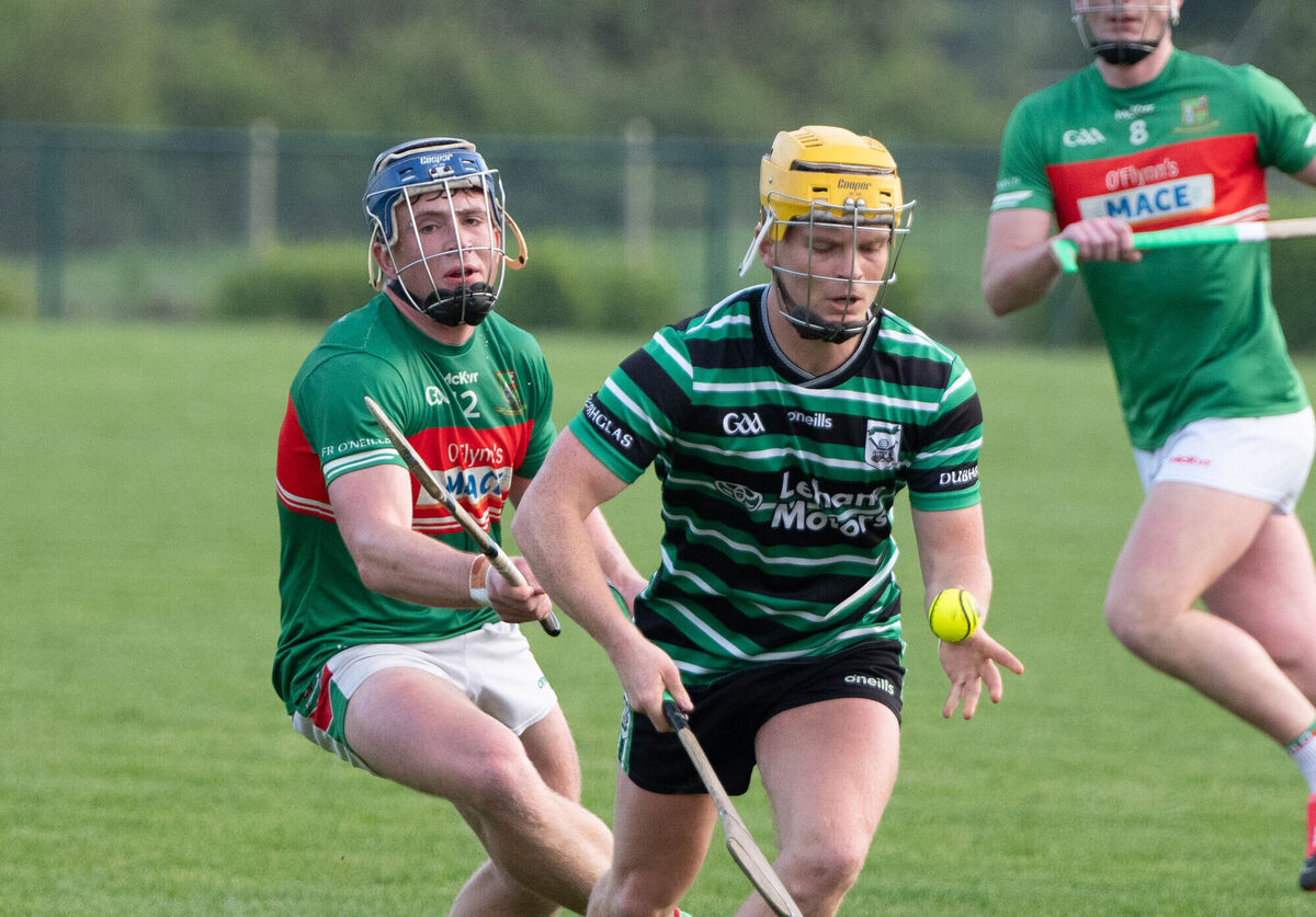 Sean O'Leary of Douglas about to handpass the sliotar ahead of Jack Finn of Fr O'Neill's. Picture: Howard Crowdy